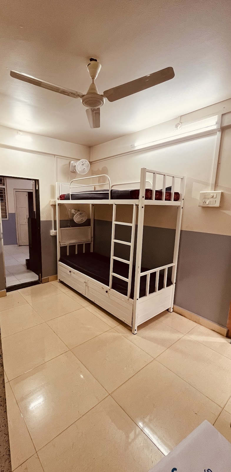 Bunk Bed Dormitory Setup with Ceiling Fan