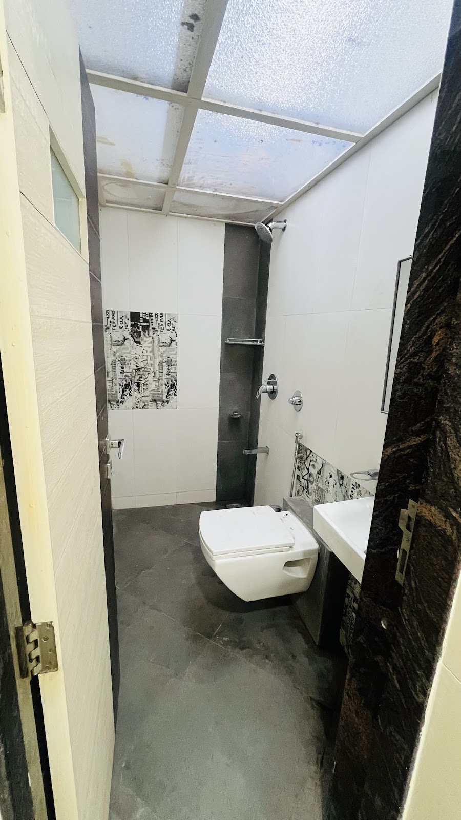 Modern Attached Washroom with Wall-Hung Commode & Skylight