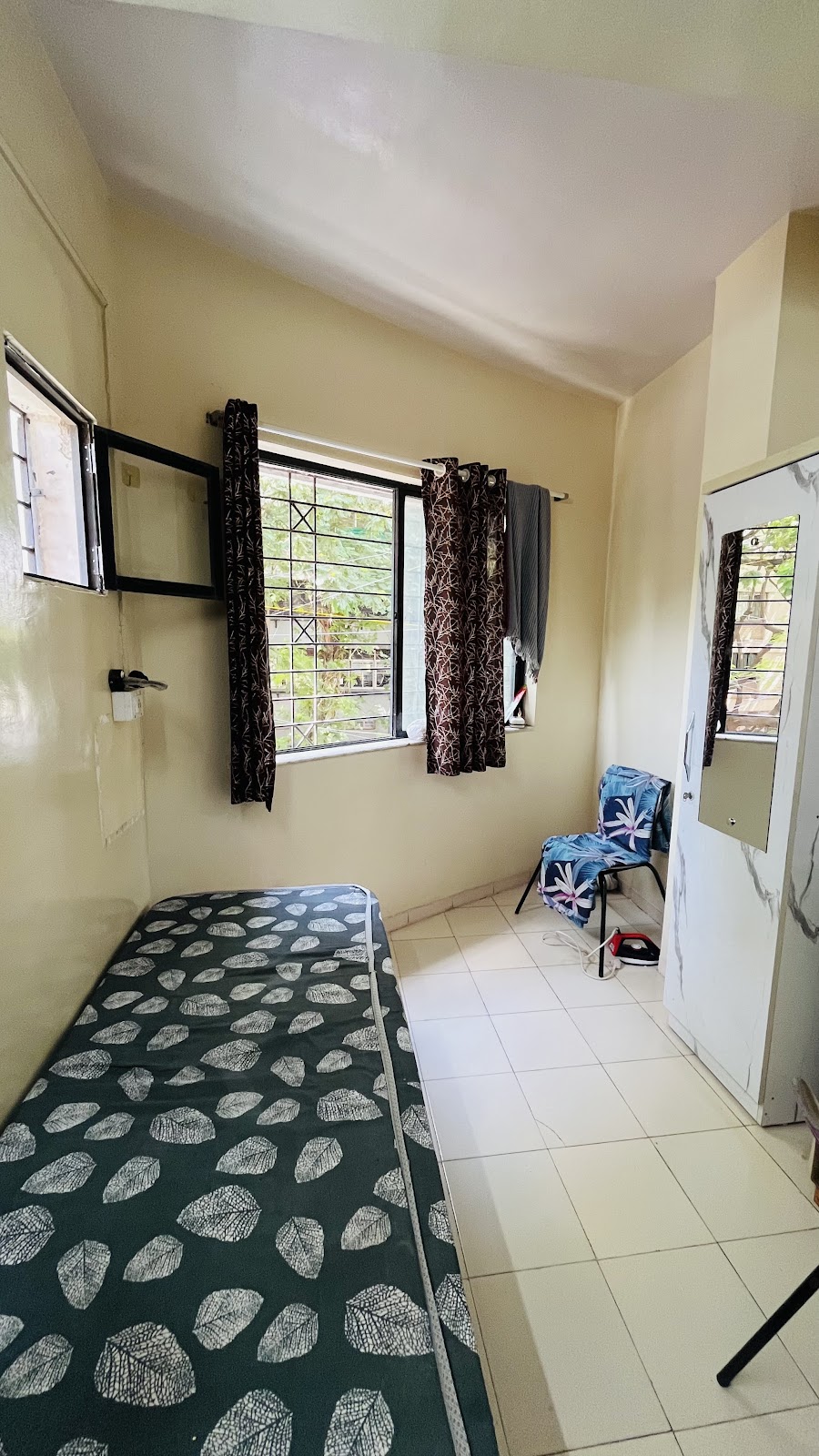 Bed Beside Window with Cupboard & Ironing Area