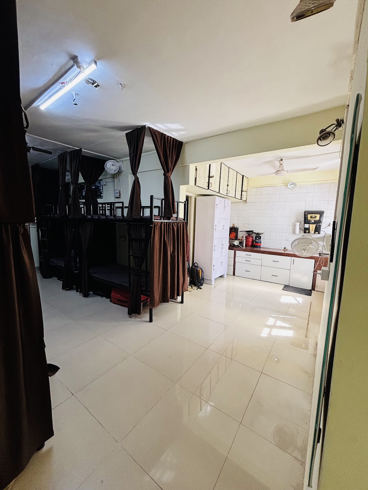 Wide View of Curtained Beds Opening into Kitchen Area